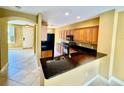 Well-lit kitchen features granite counters, dark appliances, and a view towards entryway at 5620 Whitehead St, Bradenton, FL 34203
