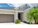 Stylish front exterior featuring a welcoming entrance, neutral paint, and a two-car garage at 5927 Maidenstone Way, Palmetto, FL 34221