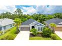 Beautiful single-story home with a well-maintained lawn, a two-car garage, and lush trees at 5927 Maidenstone Way, Palmetto, FL 34221