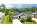 Charming single-story home with a two-car garage, well-kept lawn, and a nice green tree at 5927 Maidenstone Way, Palmetto, FL 34221