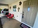 Inviting front porch with seating, creating a warm and welcoming entrance to the home at 6048 Merril St, North Port, FL 34287