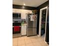 Well-equipped kitchen featuring stainless steel appliances and convenient pantry access at 6048 Merril St, North Port, FL 34287