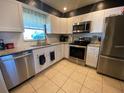 Modern kitchen with stainless steel appliances, granite countertops, and ample cabinet space at 6048 Merril St, North Port, FL 34287