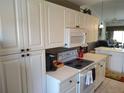 Kitchen features abundant white cabinetry, updated appliances and counterspace at 6821 Fairview Ter # 6821, Bradenton, FL 34203