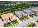 Aerial view of a condo community with lake views and well-maintained landscaping at 7387 Divot Loop # 15-D, Lakewood Ranch, FL 34202
