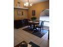 Elegant dining room featuring tile floors, a modern chandelier, and a stylish buffet at 853 Albritton Ave, Sarasota, FL 34232