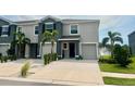 Townhome with a one-car garage, neat landscaping, and a manicured lawn in a well-kept community at 8995 Milestone Dr, Sarasota, FL 34238