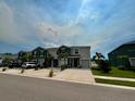 Neighborhood street view showcasing townhomes with garages, landscaped front yards, and well-maintained lawns at 8995 Milestone Dr, Sarasota, FL 34238