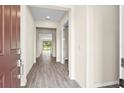 Inviting foyer with beautiful wood-look flooring that leads into the bright, open-concept living spaces of the home at 9292 Tequila Sunrise Dr, Sarasota, FL 34241