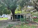 Cozy single-story house with carport nestled amongst mature trees, blending comfort and nature at 9344 Peony St, New Port Richey, FL 34654