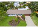 Charming single-story home with a well-manicured lawn and beautiful tropical landscaping at 1004 68Th Nw St, Bradenton, FL 34209