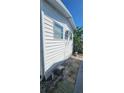 Side view of home, showcasing the exterior siding, windows, and a small space; great potential for customization at 10315 Cortez W Rd # 24-2, Bradenton, FL 34210