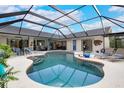 Inviting pool area with a screened enclosure and ample lounge seating at 1071 Owl Dr, Englewood, FL 34223