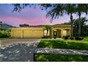 Charming yellow single story home with a three car garage and mature landscaping at 11009 Wildcat Dr, Riverview, FL 33579