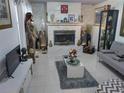 Inviting living room with a cozy fireplace, tile flooring, and modern decor at 1209 Croydonwood Cir, Brandon, FL 33510