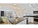 Bright, open-concept kitchen with granite countertops and stainless steel appliances overlooking the living area at 1257 S Portofino Dr # 306, Sarasota, FL 34242