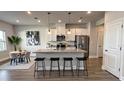 Modern kitchen featuring an island with seating, stainless steel appliances, and ample counter space at 14312 Crimson Ave, Bradenton, FL 34211