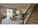 Bright living room with large sectional sofa, stylish rug, and sliding glass doors to outdoor space at 14312 Crimson Ave, Bradenton, FL 34211