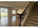 Spacious living room open to kitchen with ample natural light and modern staircase, offering a welcoming space at 14312 Crimson Ave, Bradenton, FL 34211