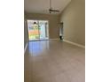 Bright living room with sliding glass doors leading to the lanai at 185 Wood Dove Ave, Tarpon Springs, FL 34689