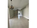 Open-concept living room with tile floors, vaulted ceilings, and lots of natural light at 185 Wood Dove Ave, Tarpon Springs, FL 34689