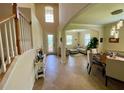 Bright and open foyer showcases tile flooring, with views of the dining area and a comfortable living space at 20940 Valore Ct, Venice, FL 34293