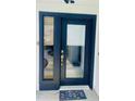 Stylish front door with sidelight and dark trim welcomes you home at 2200 E Village Ct, Venice, FL 34293