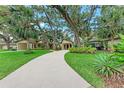 Inviting home featuring mature trees, a winding driveway, and lush landscaping, creating a serene setting at 2237 Circlewood Dr # 18, Sarasota, FL 34231