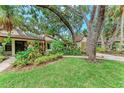 Beautiful home surrounded by mature landscaping, vibrant green grass, and charming curb appeal at 2237 Circlewood Dr # 18, Sarasota, FL 34231