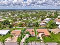 Expansive aerial view of a home with a pool in a lush neighborhood near a lake at 227 Monet Dr, Nokomis, FL 34275