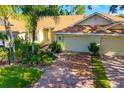Beautiful single-story home showcasing a brick driveway and well-maintained landscaping at 2411 New Haven Cir # 70, Sun City Center, FL 33573
