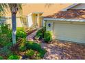 Inviting single-story home boasting a brick pathway and meticulously landscaped yard at 2411 New Haven Cir # 70, Sun City Center, FL 33573
