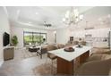 Open living space with eat in kitchen with pendant lighting and modern furnishings at 25143 Spartina Dr, Venice, FL 34293