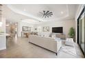 Spacious living room with modern furnishings, neutral color palette, and tile floors at 25143 Spartina Dr, Venice, FL 34293