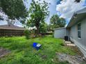 Overgrown backyard featuring a gray house at 27 Tucker Ave, Sarasota, FL 34232
