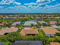 Desirable community featuring a waterfront home with a well manicured lawn and an attached three car garage at 2875 Grazeland Dr, Sarasota, FL 34240