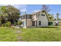Property with a uniquely styled home and spacious yard, perfect for outdoor activities and future landscaping at 305 Chauncey Ave, Bradenton, FL 34208