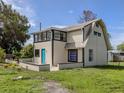 Exterior of a quaint home with a contrasting trim and a well-maintained lawn, offering a vintage aesthetic at 305 Chauncey Ave, Bradenton, FL 34208