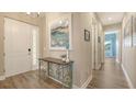 Inviting entryway with decorative table and artwork, leading to bright, open living spaces at 3430 77Th W St # 301, Bradenton, FL 34209