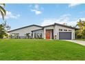 Beautiful modern home with a well-manicured lawn and sleek architectural design at 3636 Mineola, Sarasota, FL 34239