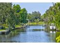 Serene waterfront view featuring a canal with private docks and lush green surroundings at 3636 Mineola, Sarasota, FL 34239