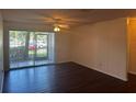 Bright and airy living room with hardwood floors and sliding glass doors to screened porch at 4002 Crockers Lake Blvd # 11, Sarasota, FL 34238