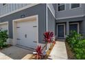 A welcoming townhome featuring a garage, front door, and tasteful landscaping for a cozy entrance at 4728 Old Blush St, Bradenton, FL 34211