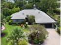 Aerial view of a well-maintained home with lush landscaping and a brick driveway at 4761 Pine Harrier Dr, Sarasota, FL 34231
