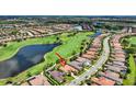 Aerial view of beautiful home in golf community with lake views and lush landscaping at 5104 Benito Ct, Bradenton, FL 34211