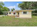 Well-kept yellow home with shutters and colorful landscaping in the front yard at 5350 Barbarossa Ave, Sarasota, FL 34235