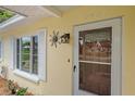Close-up of front door entrance, showing address, white trim and a decorative sun fixture at 5350 Barbarossa Ave, Sarasota, FL 34235