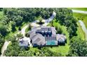 Expansive property with a screened pool area, detached garage, and a picturesque setting surrounded by lush trees at 6050 Saddle Oak Trl, Sarasota, FL 34241
