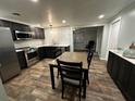 Modern kitchen featuring stainless steel appliances, stylish countertops, and an adjacent dining space at 611 Missouri Rd, Venice, FL 34293