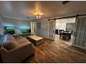 Inviting living room with wood floors, sliding doors and views into the kitchen at 611 Missouri Rd, Venice, FL 34293